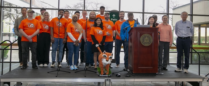 A group of people standing together on a stage